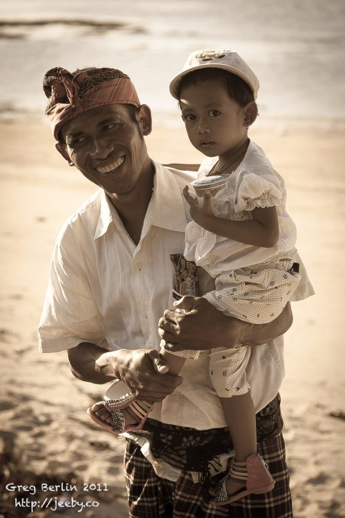Man & his son on the beach at Sekotong, Lombok, Indonesia