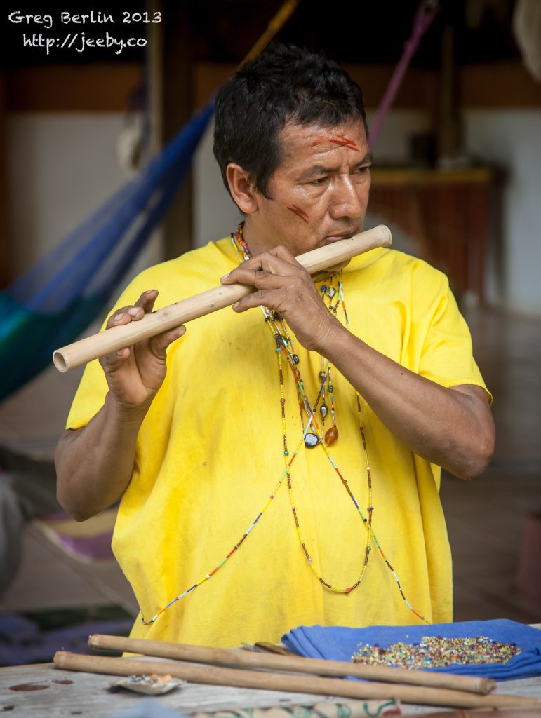 A Siekopai Elder tweaks his newly made flute at Guaria de Osa, Costa Rica